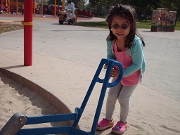 A child playing in the sandbox at park day